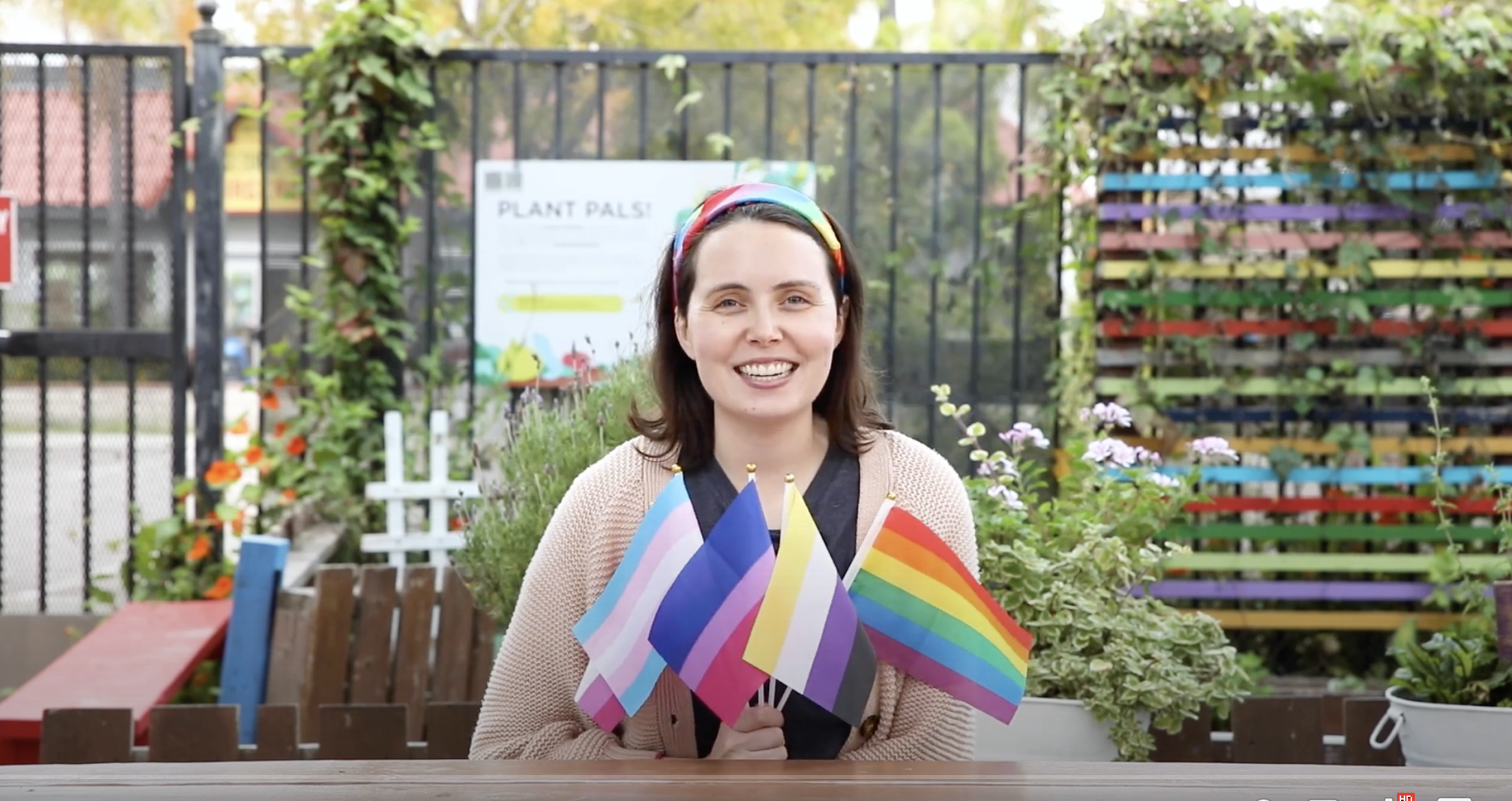 Ms Brooke holding pride flags